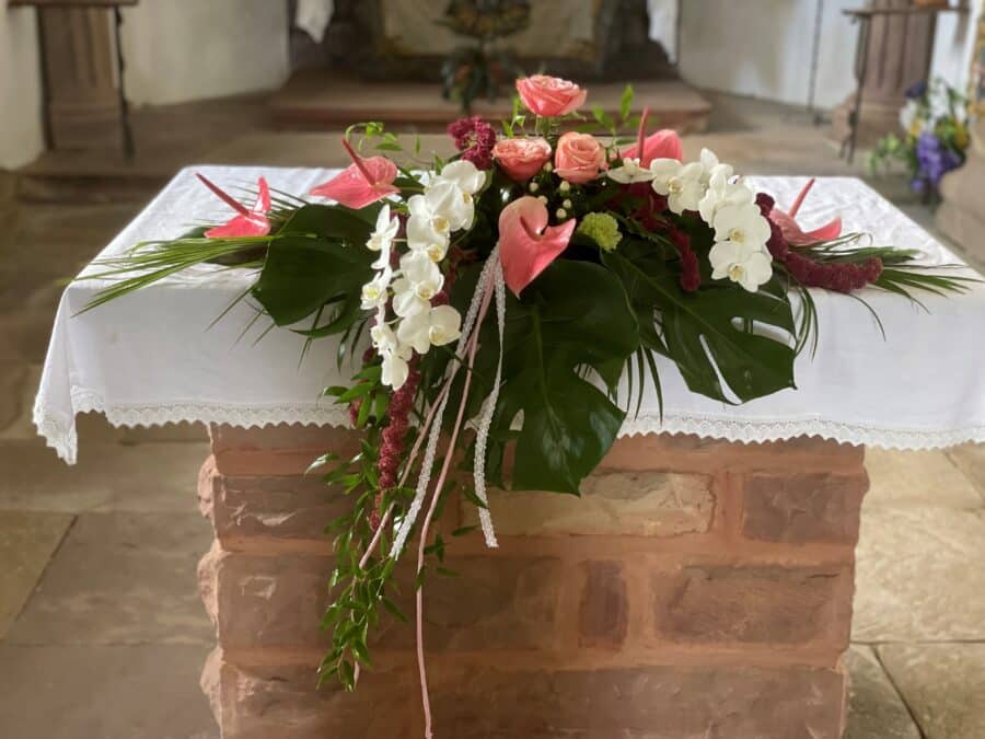 Arrangement autel blanc et rose avec anthurium et orchidées
